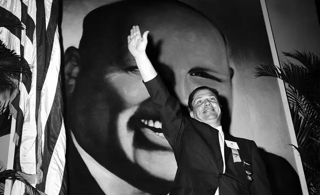 FILE - In this Sept. 30, 1957, file photo Jimmy Hoffa, Teamsters vice president and leading candidate to succeed Dave Beck as the IBT's new president, waves to delegates at the opening of the Teamsters Union convention at Miami Beach, Fla. (AP Photo/File)