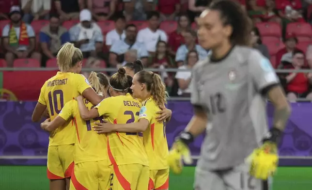 Belgium's Tessa Wullaert celebrates with teammates after scoring her sides first goal during the Women¥s Euro 2025, group B, soccer match between Portugal and Belgium at Stade de Tourbillon in Sion, Switzerland, Friday, July 11, 2025. (AP Photo/Alessandra Tarantino)