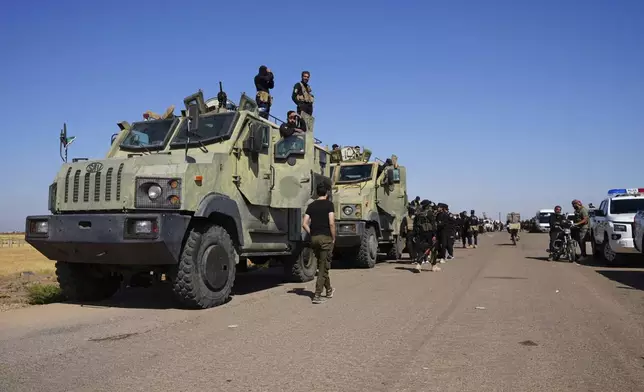 Syrian government security forces gather on the outskirts of Sweida province where clashes erupted between Druze militias and Sunni Bedouin clans, southern Syria, Monday, July 14, 2025. (AP Photo/Malek Khattab)