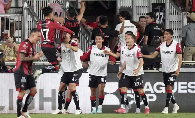 Atlas defender Jose Lozano (17) celebrates with substitutes warming up on the sideline after scoring his side's first goal against Inter Miami, during the second half of a Leagues Cup group stage soccer match, Wednesday, July 30, 2025, in Fort Lauderdale, Fla. (AP Photo/Rebecca Blackwell)