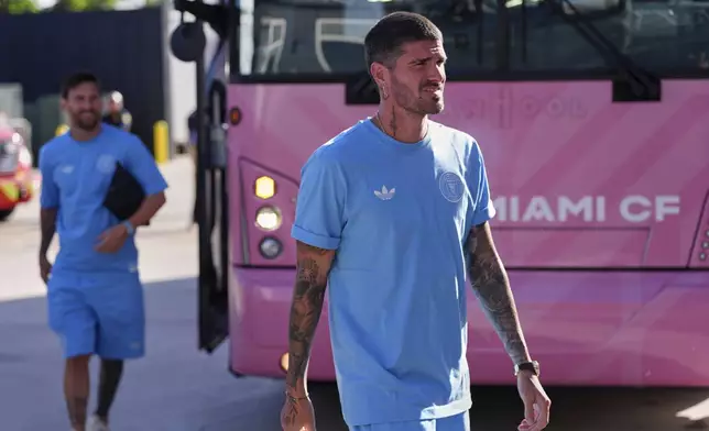 Inter Miami midfielder Rodrigo De Paul, right, and forward Lionel Messi arrive ahead of a Leagues Cup group stage soccer match against Atlas, Wednesday, July 30, 2025, in Fort Lauderdale, Fla. (AP Photo/Rebecca Blackwell)