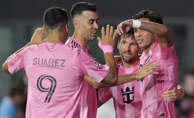 Inter Miami midfielder Telasco Segovia, right, celebrates scoring his side's first goal, along with teammates forward Lionel Messi, second right, and midfielder Sergio Busquets, second left, during the second half of a Leagues Cup group stage soccer match against Atlas, Wednesday, July 30, 2025, in Fort Lauderdale, Fla. (AP Photo/Rebecca Blackwell)