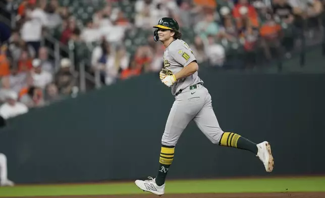 Athletics' Nick Kurtz smiles as he runs the bases after hitting a home run against the Houston Astros during the eighth inning of a baseball game Friday, July 25, 2025, in Houston. (AP Photo/David J. Phillip)