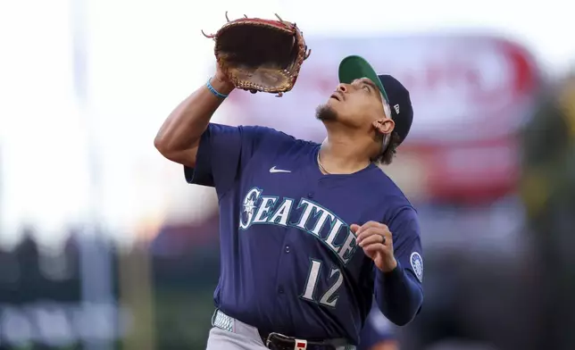 Seattle Mariners first baseman Josh Naylor fields a ball during the second inning of a baseball game against the Los Angeles Angels, Friday, July 25, 2025, in Anaheim, Calif. (AP Photo/Eric Thayer)