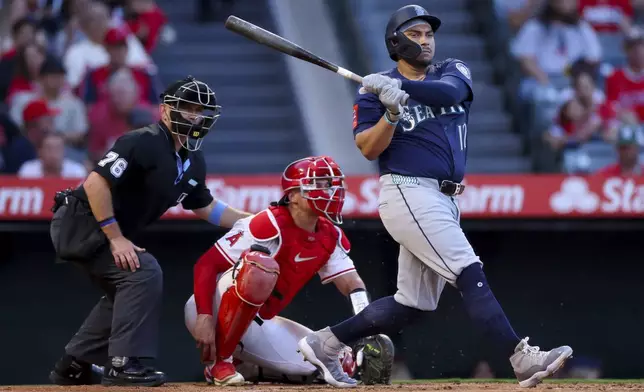Seattle Mariners' Josh Naylor (12) hits a pitch during the third inning of a baseball game against the Los Angeles Angels, Friday, July 25, 2025, in Anaheim, Calif. (AP Photo/Eric Thayer)