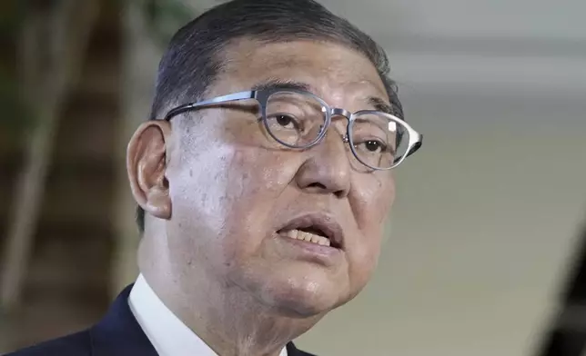 Japanese Prime Minister Shigeru Ishiba speaks to the media as President Donald Trump announced a trade framework with Japan, at the prime minister's office in Tokyo, Japan, Wednesday, July 23, 2025. (Kyodo News via AP)