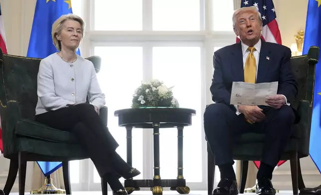 President Donald Trump reads from a paper and European Commission President Ursula von der Leyen listens after reaching a trade deal between the U.S. and the EU at the Trump Turnberry golf course in Turnberry, Scotland Sunday, July 27, 2025. (AP Photo/Jacquelyn Martin)