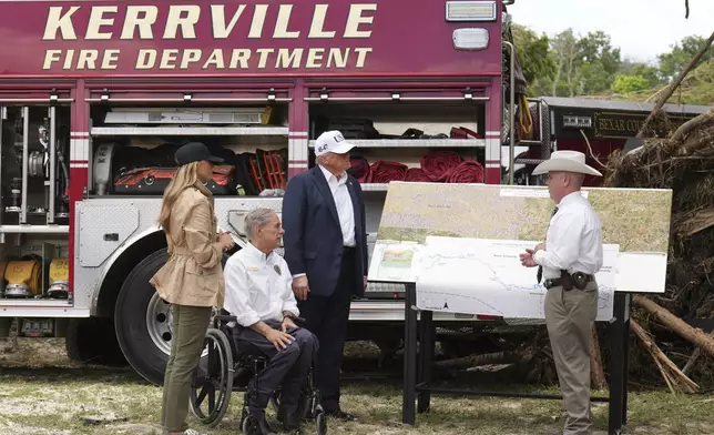 First lady Melania Trump, from left, Texas Gov. Greg Abbott and President Donald Trump are briefed on flood damage in Kerrville, Texas, Friday, July 11, 2025. (AP Photo/Jacquelyn Martin)