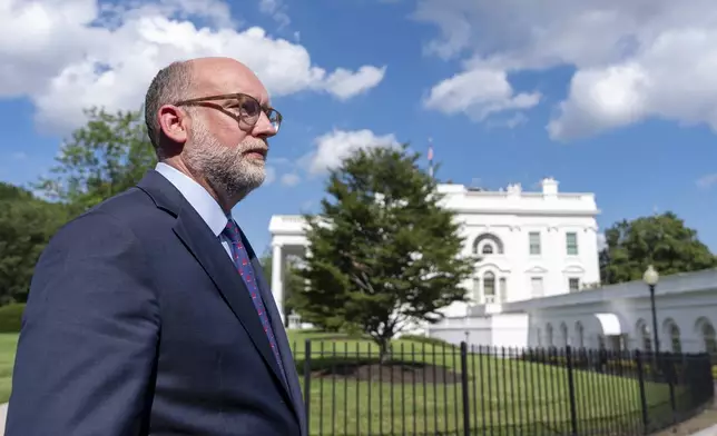 Office of Management and Budget Director Russell Vought walks at the White House, Monday, July 7, 2025, in Washington. (AP Photo/Alex Brandon)