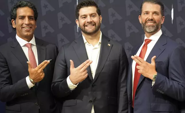 GrabAGun CEO Marc Nemati, center, board member Donald Trump, Jr., right, and financier Omeed Malik pose for a picture on the floor at the New York Stock Exchange in New York, Wednesday, July 16, 2025. (AP Photo/Seth Wenig)