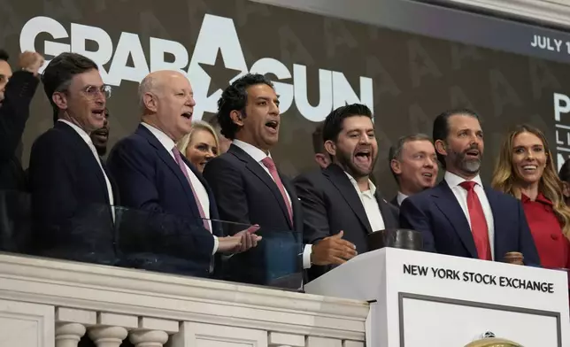 GrabAGun board member Donald Trump, Jr., second from right, CEO Marc Nemati, fourth from right, and others ring the opening bell at the New York Stock Exchange in New York, Wednesday, July 16, 2025. (AP Photo/Seth Wenig)