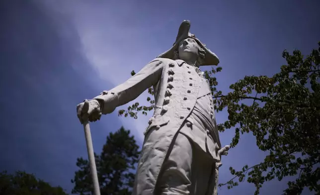 A statue of King Frederick II of Prussia stands in the park of Sanssouci Palace in Potsdam, Germany, June 17, 2025. (AP Photo/Markus Schreiber)