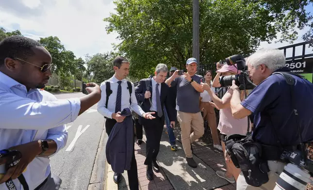 David Oscar Markus, attorney for Ghislaine Maxwell, center, is questioned by the media outside the federal courthouse in Tallahassee, Fla., Thursday, July 24, 2025. (AP Photo/John Raoux)