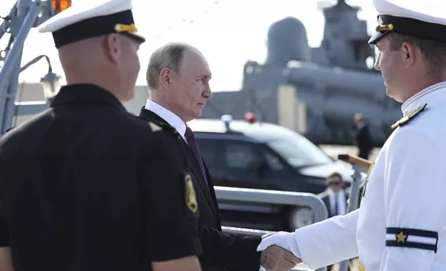 Russian President Vladimir Putin, second left arrives to visit the frigate "Admiral Grigorovich" in Kronstadt, outside St. Petersburg during Navy Day celebration, Russia, on Sunday, July 27, 2025. (Alexander Kazakov, Sputnik, Kremlin Pool Photo via AP)