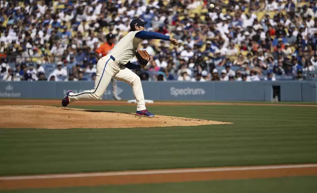 Los Angeles Dodgers starting pitcher Shohei Ohtani delivers during the first inning of a baseball game against the Houston Astros in Los Angeles, Saturday, July 5, 2025. (AP Photo/Kyusung Gong)