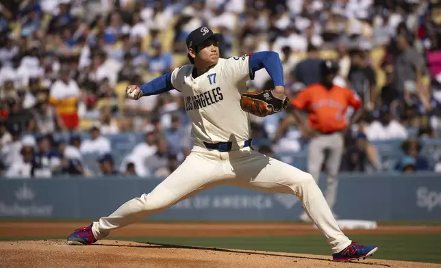 Los Angeles Dodgers starting pitcher Shohei Ohtani delivers during the first inning of a baseball game against the Houston Astros in Los Angeles, Saturday, July 5, 2025. (AP Photo/Kyusung Gong)
