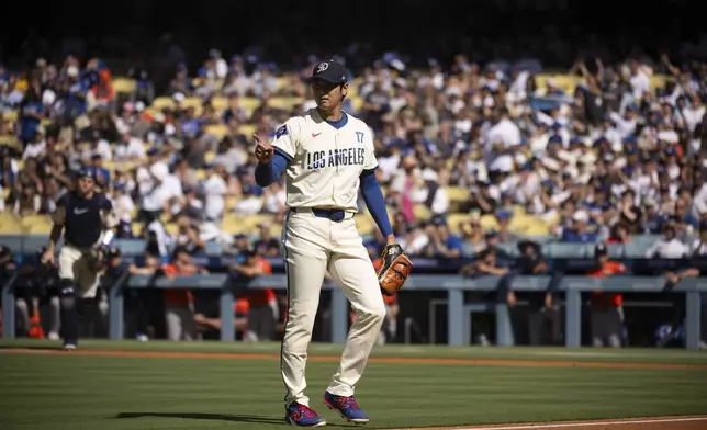 Los Angeles Dodgers starting pitcher Shohei Ohtani gestures during the first inning of a baseball game against the Houston Astros in Los Angeles, Saturday, July 5, 2025. (AP Photo/Kyusung Gong)