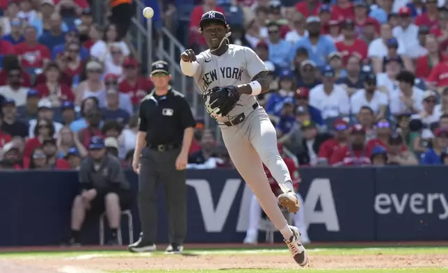 New York Yankees second baseman Jazz Chisholm Jr. (13) throws to first base but Toronto Blue Jays' Davis Schneider, not pictured, is safe during the fourth inning of a baseball game in Toronto on Tuesday, July 1, 2025. (Frank Gunn/The Canadian Press via AP)