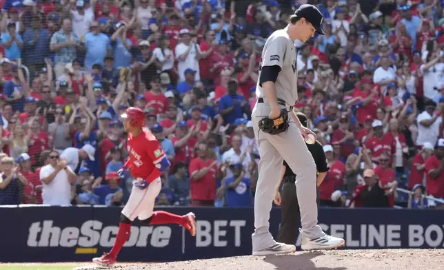 New York Yankees pitcher Max Fried (54) reacts as Toronto Blue Jays' George Springer (4) rounds the bases after hitting a solo home run during the fourth inning of a baseball game in Toronto on Tuesday, July 1, 2025. (Frank Gunn/The Canadian Press via AP)
