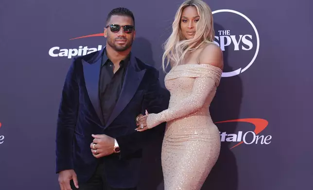Russell Wilson, left, and his wife, Ciara, arrive at the ESPY Awards at the Dolby Theatre in Los Angeles, Wednesday, July 16, 2025. (AP Photo/Chris Pizzello)