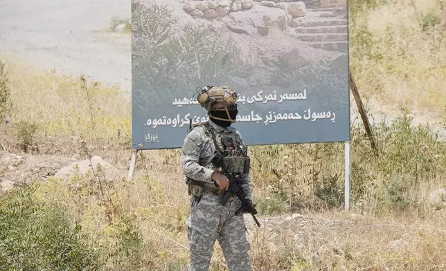 Forces of the regional Kurdish administration secure the area of the Jasana Cave ahead of a symbolic disarmament ceremony by the separatist PKK group as part of the peace process with Turkey, in Sulaymaniyah governorate, Iraq, Friday, July 11, 2025. (AP Photo/Hadi Mizban)