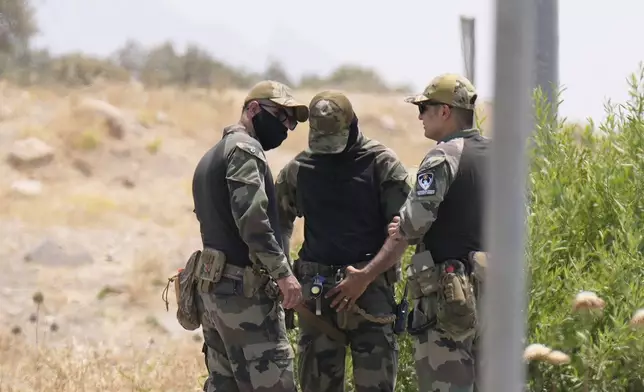 Forces of the regional Kurdish administration secure the area of the Jasana Cave ahead of a symbolic disarmament ceremony by the separatist PKK group as part of the peace process with Turkey, in Sulaymaniyah governorate, Iraq, Friday, July 11, 2025. (AP Photo/Hadi Mizban)