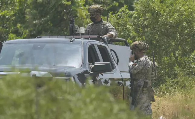 Forces of the regional Kurdish administration secure the area of the Jasana Cave ahead of a symbolic disarmament ceremony by the separatist PKK group as part of the peace process with Turkey, in Sulaymaniyah governorate, Iraq, Friday, July 11, 2025. (AP Photo/Hadi Mizban)