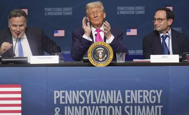 President Donald Trump, center, seated with Sen. Dave McCormick, R-Pa., left, and Jon Gray, President and Chief Operating Officer, Blackstone, right, at the "Inaugural Pennsylvania Energy and Innovation Event" at Carnegie Mellon University, Tuesday, July 15, 2025, in Pittsburgh. (AP Photo/Gene J. Puskar)