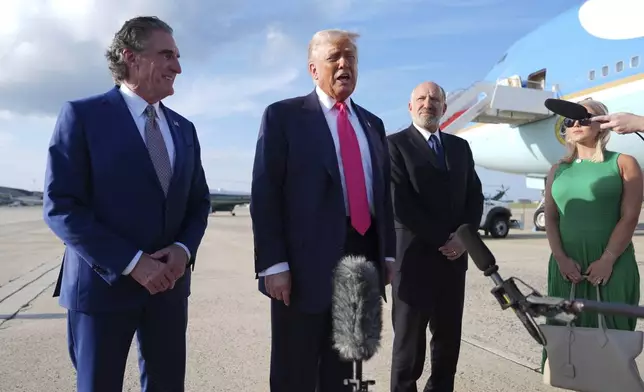 President Donald Trump speaks to the media after arriving at Joint Base Andrews, Tuesday, July 15, 2025, in Joint Base Andrews, Md., as Secretary of the Interior Doug Burgum, left, Secretary of Commerce Howard Lutnick and White House Press Secretary Karoline Leavitt, right, look on. (AP Photo/Evan Vucci)