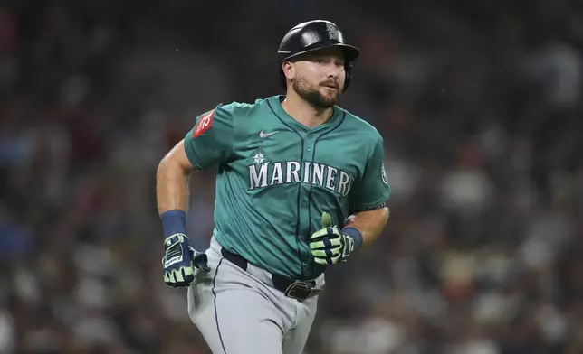 Seattle Mariners' Cal Raleigh rounds first base after hitting a grand slam against the Detroit Tigers in the ninth inning during a baseball game, Friday, July 11, 2025, in Detroit. (AP Photo/Paul Sancya)