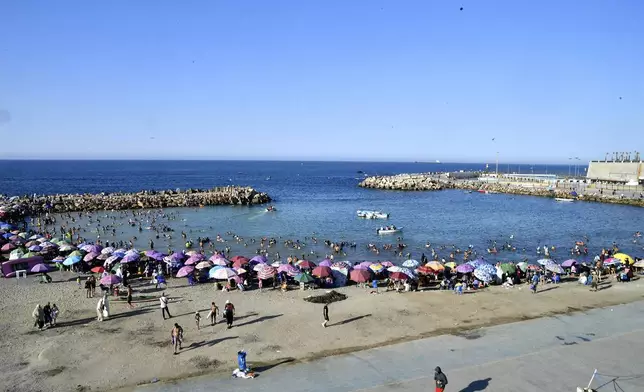 People enjoy the beach in Algiers, Friday, July 18, 2025. (AP Photo/Fateh Guidoum)