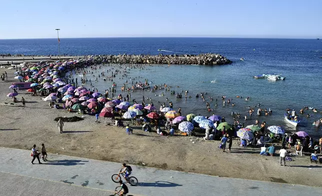 People enjoy the beach in Algiers, Friday, July 18, 2025. (AP Photo/Fateh Guidoum)
