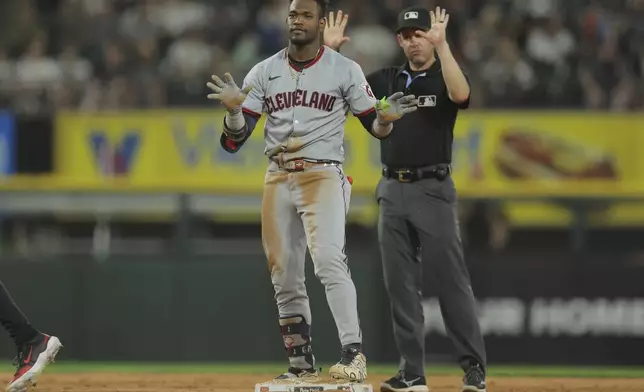 Cleveland Guardians' Angel Martínez, left, celebrates after hitting an RBI double during the seventh inning in the second baseball game of a doubleheader against the Chicago White Sox, Friday, July 11, 2025, in Chicago. (AP Photo/Melissa Tamez)