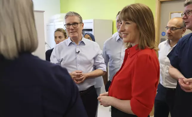 Britain's Prime Minister Keir Starmer, center, Chancellor Rachel Reeves during a visit to the Sir Ludwig Guttman Health &amp; Wellbeing Centre in east London, Thursday, July 3, 2025. (Jack Hill/Pool Photo via AP)