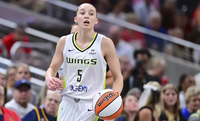 Dallas Wings' Paige Bueckers dribbles during the first half of a WNBA basketball game against the Indiana Fever, Sunday, July 13, 2025, in Indianapolis. (AP Photo/Doug McSchooler)