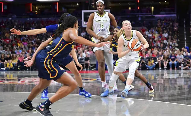 Dallas Wings' Paige Bueckers (5) makes a pass during the first half of a WNBA basketball game against the Indiana Fever, Sunday, July 13, 2025, in Indianapolis. (AP Photo/Doug McSchooler)