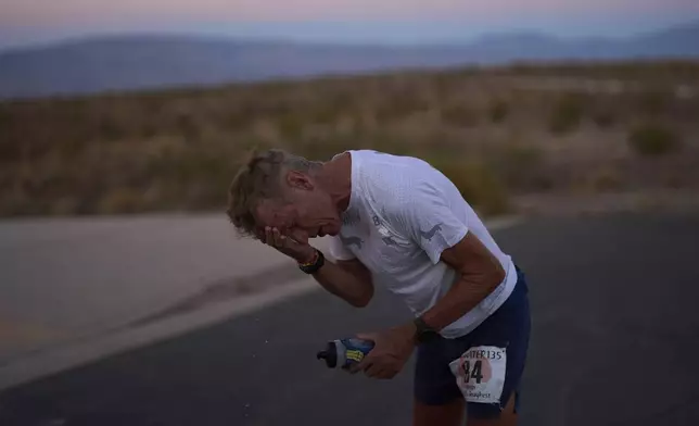 Danny Westergaard reacts while taking a break around the 24-hour mark during the Badwater 135 Ultramarathon, Tuesday, July 8, 2025, in Death Valley National Park, Calif. (AP Photo/John Locher)