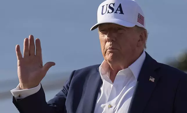 President Donald Trump waves to the media after exiting Air Force One, at Joint Base Andrews, Md., Sunday, July 6, 2025, en route to the White House after spending the weekend in New Jersey. (AP Photo/Jacquelyn Martin)
