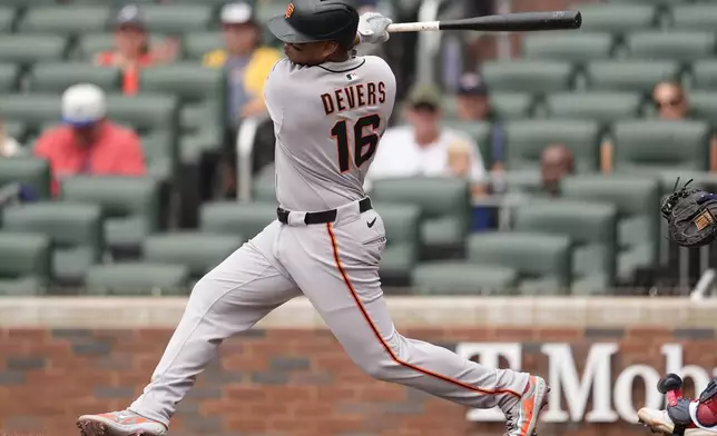 San Francisco Giants designated hitter Rafael Devers (16) hits a single in the first inning of a baseball game against the Atlanta Braves, Wednesday, July 23, 2025, in Atlanta. (AP Photo/Mike Stewart)