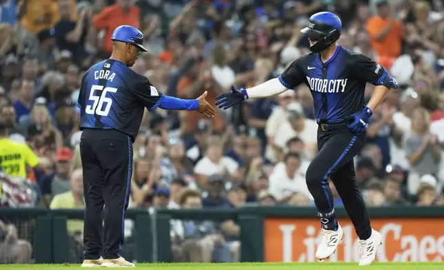 Detroit Tigers' Spencer Torkelson, right, celebrates with third base coach Joey Cora, left, after hitting a solo home-run during the sixth inning of a baseball game against the Toronto Blue Jays, Friday, July 25, 2025, in Detroit. (AP Photo/Ryan Sun)