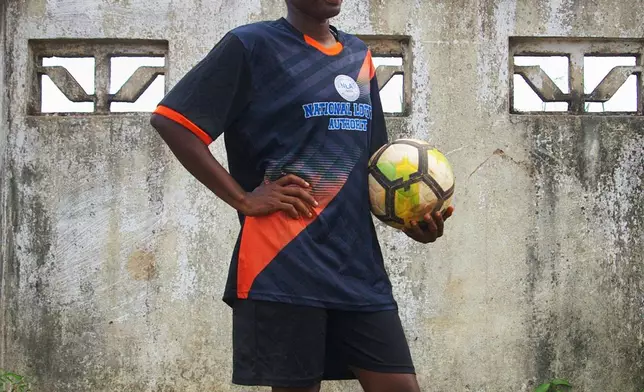 Perryline Jimmie, 23, on the Gisa kickball team, poses for a photo after a match at the Samuel Kanyon Doe Stadium in Monrovia, Liberia, June 14, 2025. (AP Photo/Annie Risemberg)