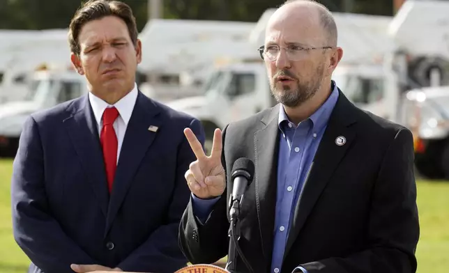 FILE - Kevin Guthrie, director of Florida Division of Emergency Management, right, gestures as Florida Gov. Ron DeSantis looks on during a news conference, Sept. 25, 2024, at the Tampa Electric Company offices in Tampa, Fla. (AP Photo/Chris O'Meara, File)
