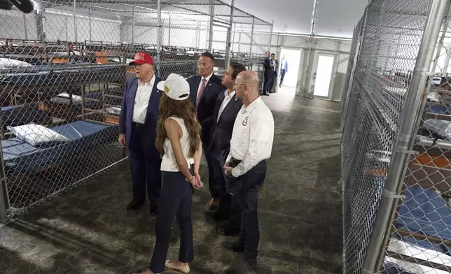 President Donald Trump speaks with reporters as he tours "Alligator Alcatraz," a new migrant detention facility at Dade-Collier Training and Transition facility, Tuesday, July 1, 2025, in Ochopee, Fla. (AP Photo/Evan Vucci)