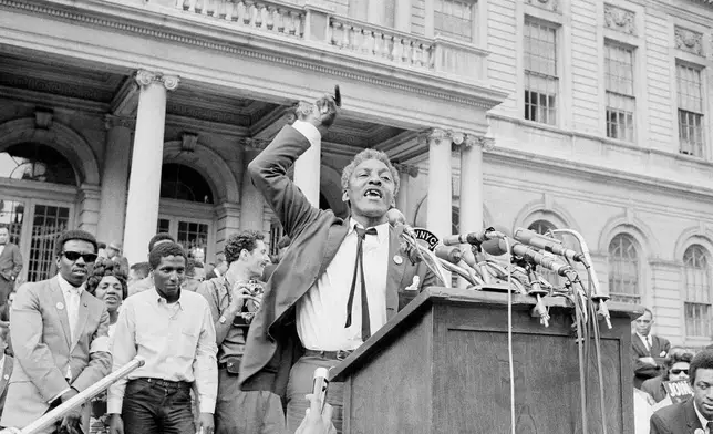 FILE - Bayard Rustin, civil rights organizer, speaks from a platform erected in front of New York's City Hall, May 18, 1964, as a crowd of some 3,000 persons rallied that was high point of day-long activities by civil rights groups seeking school integration. (AP Photo, File)
