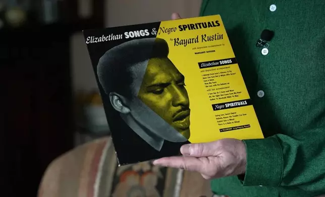 In this still image taken from video, Walter Naegle, Bayard Rustin's partner and a consultant on projects related to his life and work, holds a vinyl record in his home on Saturday, June 28, 2025, in New York. (AP Photo/Mary Conlon)