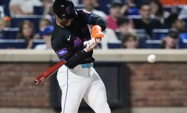 New York Mets' Francisco Lindor (12) hits an RBI single during the sixth inning in the second baseball game of a doubleheader against the Milwaukee Brewers Wednesday, July 2, 2025, in New York. (AP Photo/Frank Franklin II)