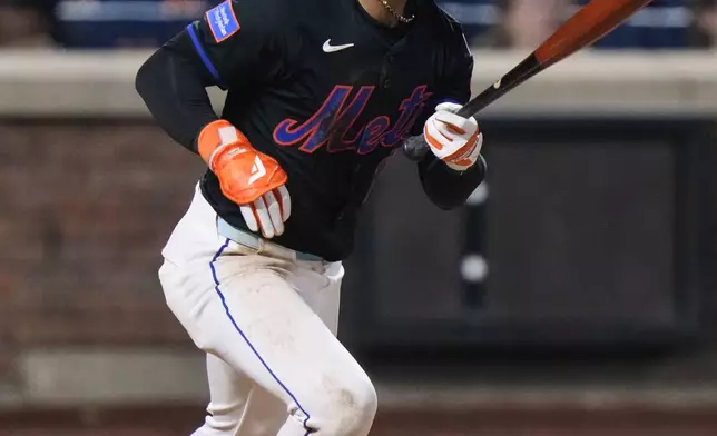 New York Mets' Francisco Lindor (12) hits an RBI double during the eighth inning in the second baseball game of a doubleheader against the Milwaukee Brewers Wednesday, July 2, 2025, in New York. (AP Photo/Frank Franklin II)