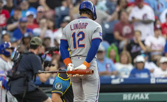 New York Mets' Francisco Lindor (12) waits at the plate while a strike call is reviewed during the first inning of a baseball game against the Philadelphia Phillies, Friday, June 20, 2025, in Philadelphia. (AP Photo/Laurence Kesterson)