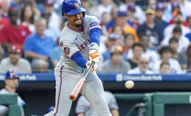 New York Mets' Francisco Lindor hits a single during the first inning of a baseball game against the Philadelphia Phillies, Sunday, June 22, 2025, in Philadelphia. (AP Photo/Laurence Kesterson)