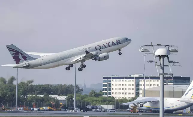 A Qatar Airways plane takes off from Leipzig/Halle Airport, Friday, July 18, 2025, Saxony, Schkeuditz. (Jan Woitas/dpa/dpa via AP)